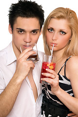 Image showing Pretty young couple with cocktails. Isolated