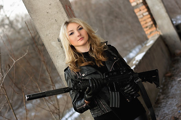 Image showing Beautiful young woman with a rifle