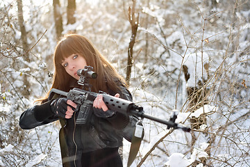 Image showing Brunette girl aiming a gun