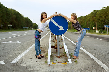 Image showing Two girls stand on a road