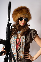 Image showing Young stylish woman with a gun