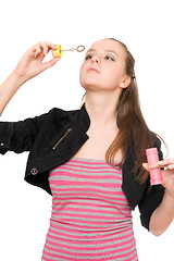 Image showing Portrait of pretty young woman blow bubbles