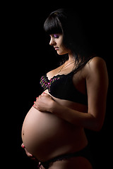 Image showing Pregnant brunette in lingerie. Isolated