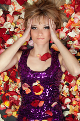 Image showing lovely young blonde lying in rose petals