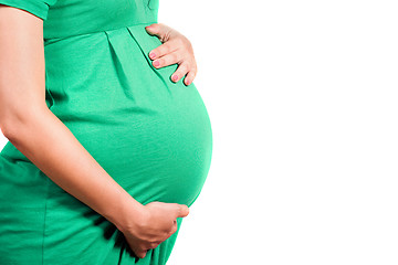 Image showing Belly of a pregnant girl in green dress