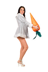 Image showing Beautiful young brunette with a carrot