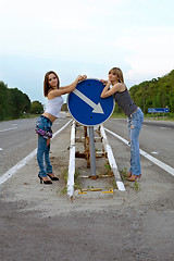 Image showing Two pretty girls stand on a road