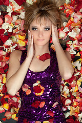 Image showing young blonde lying in rose petals