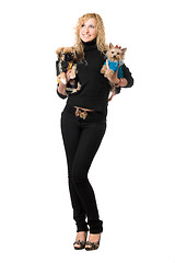 Image showing Cheerful young blonde posing with two dogs