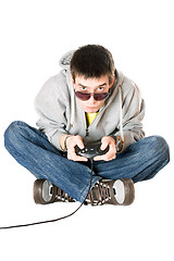 Image showing Young man in sunglasses with a joystick