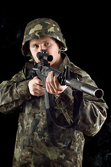 Image showing Alerted soldier keeping a gun