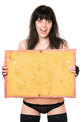 Image showing Surprised brunette taking vintage yellow board
