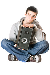 Image showing Young man with a speaker in his hands