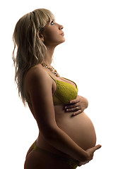 Image showing Pregnant young woman in yellow lingerie. Isolated