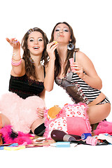 Image showing Two cheerful girls blow bubbles. Isolated