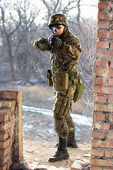 Image showing Soldier near wall with a gun