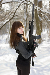 Image showing Turned lady with the gun