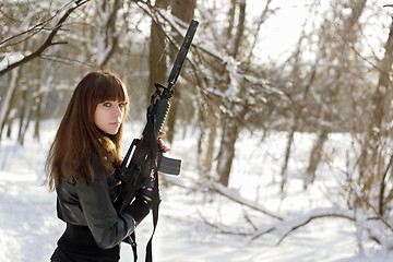 Image showing Armed woman in the winter forest