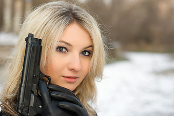 Image showing Sweet woman with a weapon