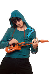 Image showing Young man in sunglasses with a little guitar