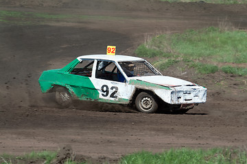 Image showing Race for survival. Green white car