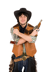 Image showing Smiling cowboy with a bottle and gun