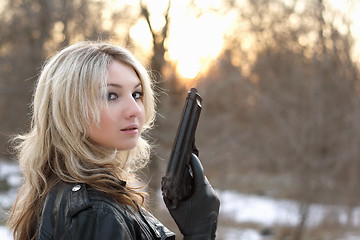 Image showing Provocative young woman with a gun