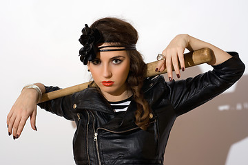 Image showing Serious young woman with a bat