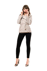 Image showing Sexy girl wearing a coat and black leggings. Isolated