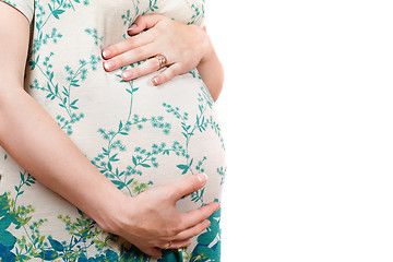 Image showing Belly of a pregnant girl in dress. Isolated