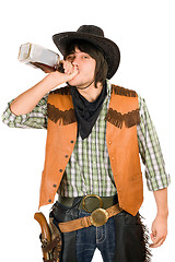 Image showing Cowboy drinking whiskey