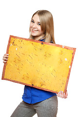 Image showing Cheerful young woman posing with yellow vintage board