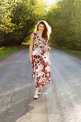 Image showing young woman walking on the road