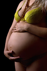 Image showing Belly of a young pregnant woman. Isolated