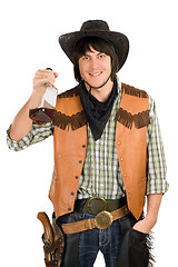 Image showing happy young cowboy with a bottle