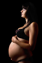 Image showing Pregnant young woman in lingerie. Isolated