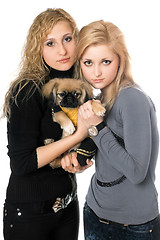 Image showing two pretty young women with pekingese