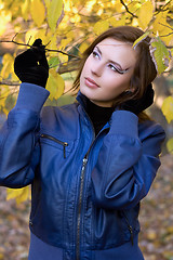 Image showing beautiful girl amongst the autumn leaves