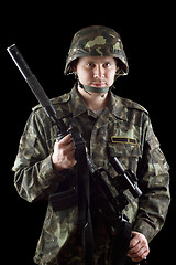 Image showing Armed soldier grasping m16