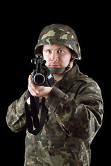 Image showing Armed man pointing a rifle