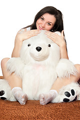 Image showing Beautiful girl sitting in an embrace with a teddy bear