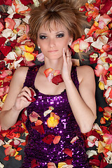 Image showing young blonde lying in rose petals