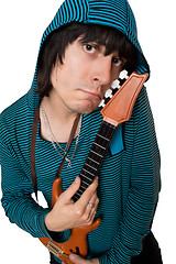 Image showing Bizarre young man with a little guitar. Isolated