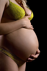Image showing Belly of a pregnant young woman. Isolated