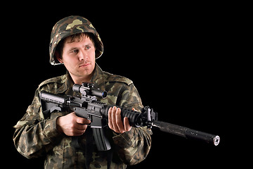 Image showing Arming soldier and a rifle
