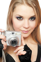 Image showing Young beautiful woman holding a photo camera