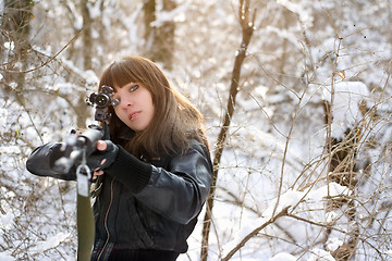 Image showing Girl aiming a gun