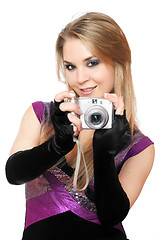 Image showing Playful blonde holding a photo camera. Isolated