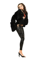 Image showing Sexy young brunette in black coat and leggings