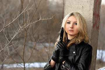 Image showing Sensual young woman holding a weapon